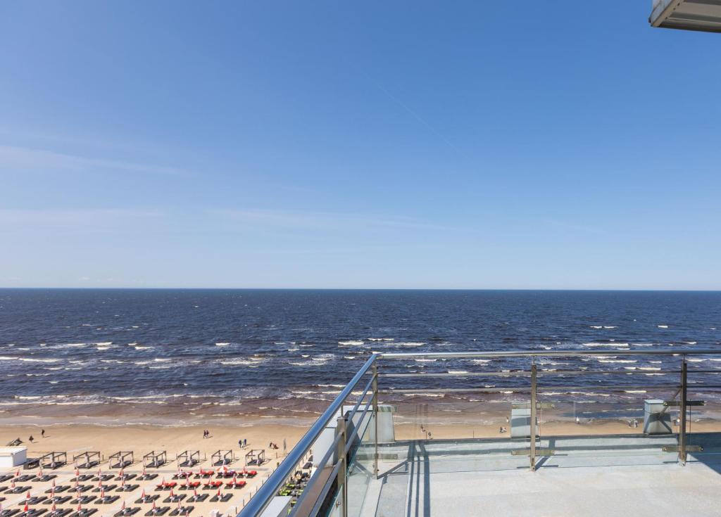 a view of a beach with chairs and the ocean at Baltic Beach Hotel & SPA in Jūrmala