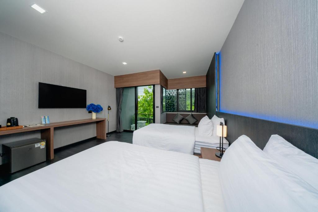 Postel nebo postele na pokoji v ubytování Happy Hotel Aonang Krabi