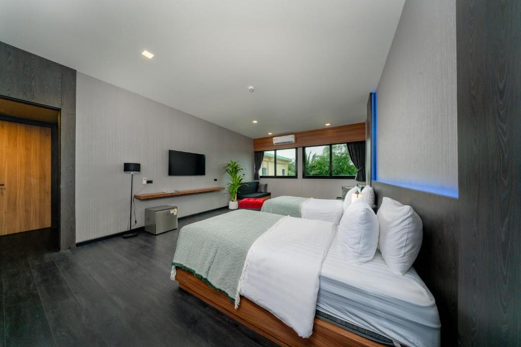 Postel nebo postele na pokoji v ubytování Happy Hotel Aonang Krabi