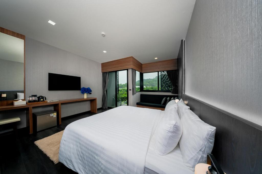 Postel nebo postele na pokoji v ubytování Happy Hotel Aonang Krabi