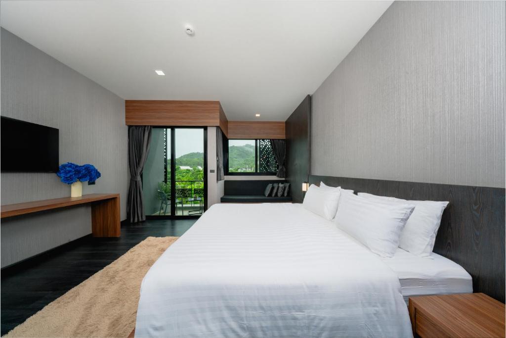 Postel nebo postele na pokoji v ubytování Happy Hotel Aonang Krabi