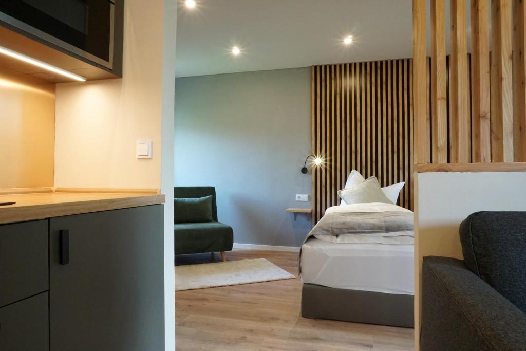 a hotel room with a bed and a couch at Panorama Apart Fichtelberg in Fichtelberg