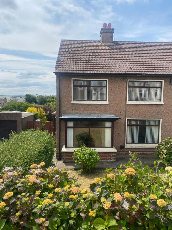 a house with a garden in front of it at Prospect Beach House 1, Portstewart in Portstewart