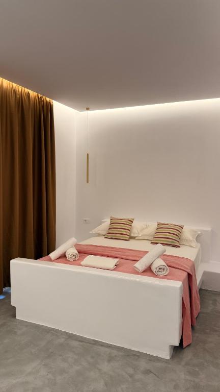 a large white bed in a white room at Rida Village Ksamil Island in Ksamil