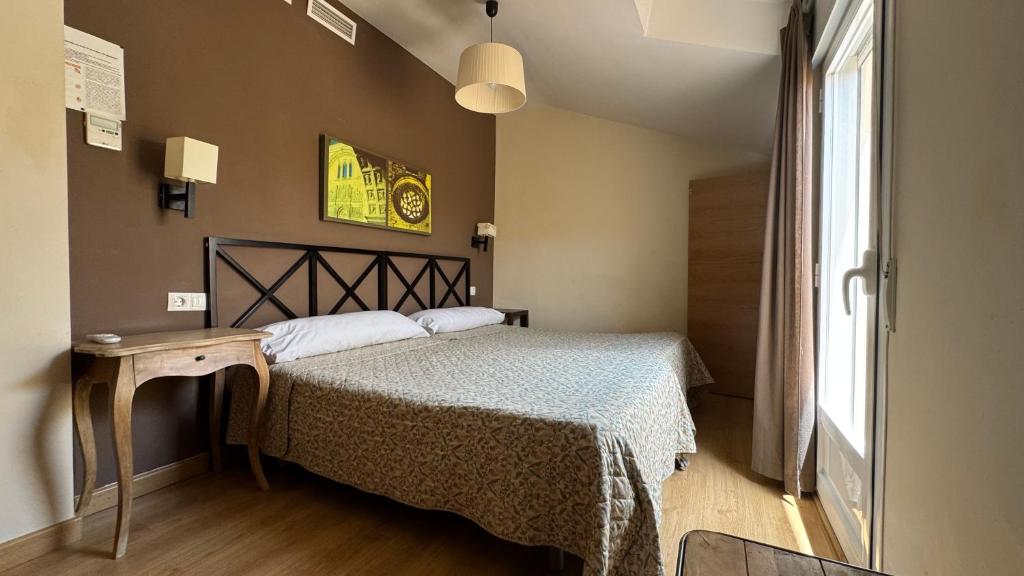 Postel nebo postele na pokoji v ubytování Apartamentos Alcazar de Baeza