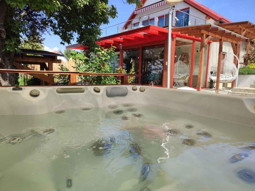 a large pool of water in front of a house at Holiday home in Siófok (Töreki) in Siófok