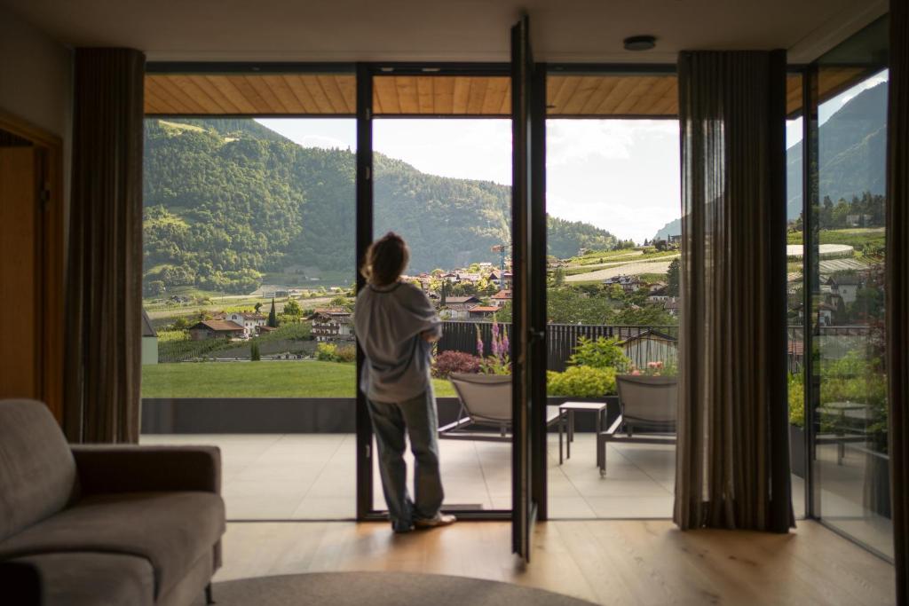 a person looking out the window of a house at Stollhof in Lagundo