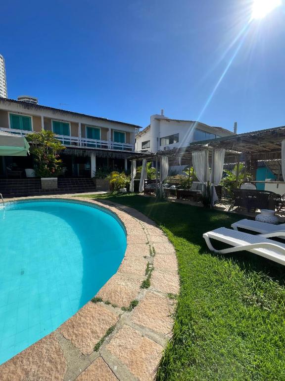 a swimming pool in front of a building at Pousada Ponta Mar in Natal