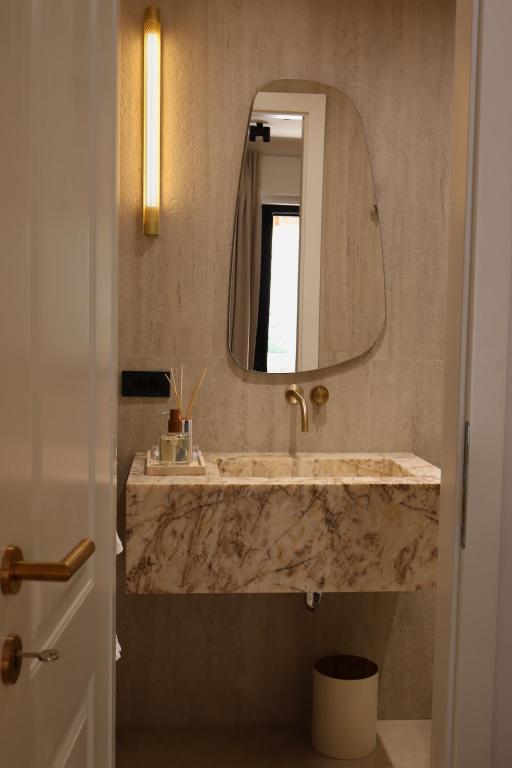 a bathroom with a marble sink and a mirror at Caleda Rooms - Boutique Stay in Dubrovnik Center in Dubrovnik