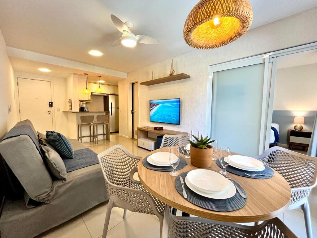 a living room with a table and a couch at Ocean View - Camboinhas Beach I 214B in Niterói