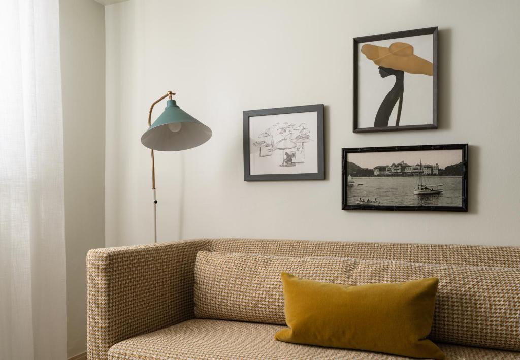 a living room with a couch and pictures on the wall at The Milo in Santa Barbara