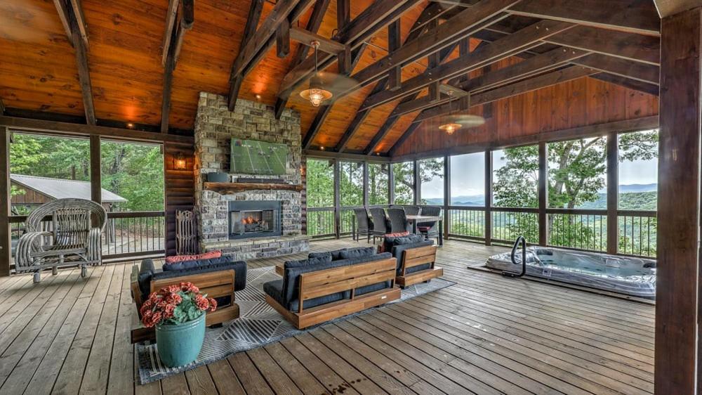 a large living room with a fireplace in a house at Ridge Top Lodge in Blue Ridge