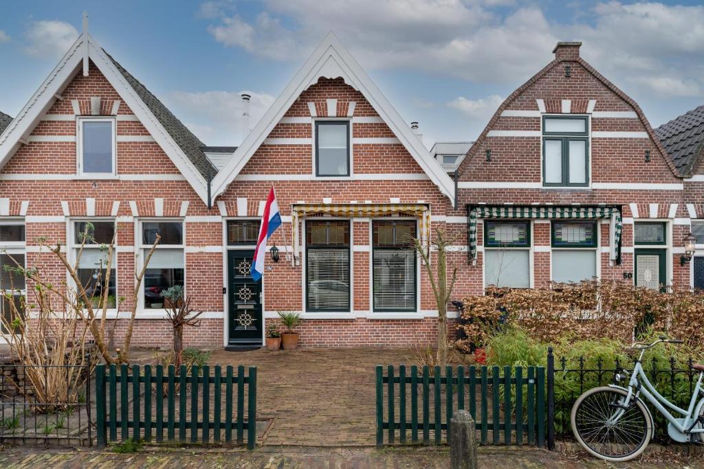 a brick house with a bike parked in front of it at House 'n Cheese - Alkmaar in Alkmaar