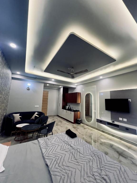 a living room with a couch and a flat screen tv at Luxury style room in Ghaziabad