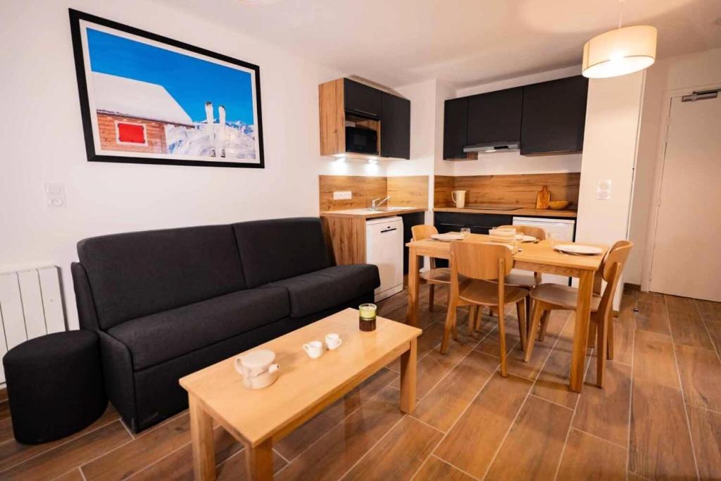 a living room with a couch and a table and a kitchen at Appartement 2 Pièces 4 Personnes MAE-3913 in Vars