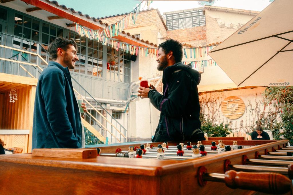 two men standing in front of a chessboard at Viajero Cusco Hostel in Cusco