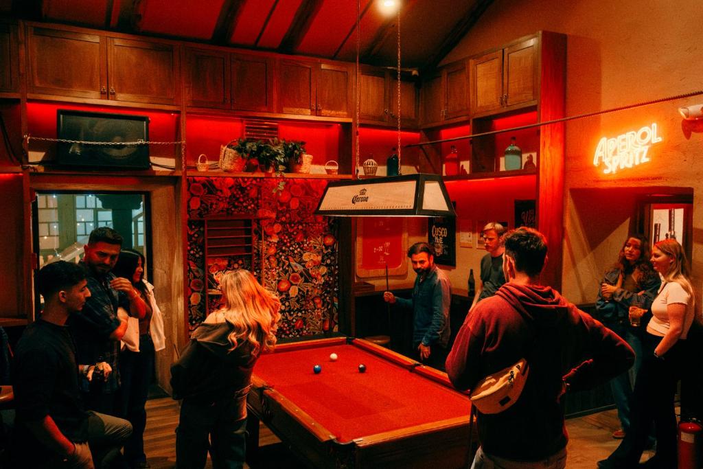a group of people in a room with a pool table at Viajero Cusco Hostel in Cusco