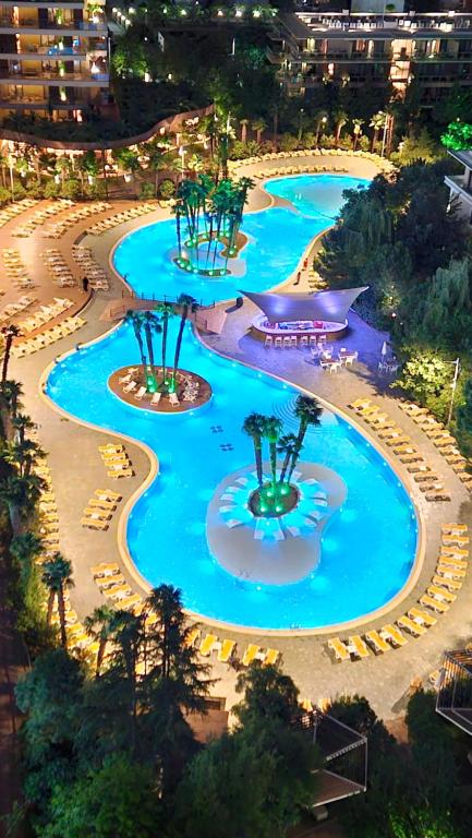 an aerial view of a resort pool at night at Dreamland Oasis 1 Studio in Chakvi