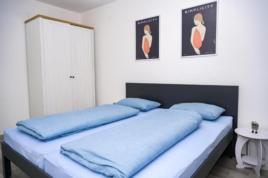 a bedroom with two blue pillows on a bed at Apartman Castello in Jajce