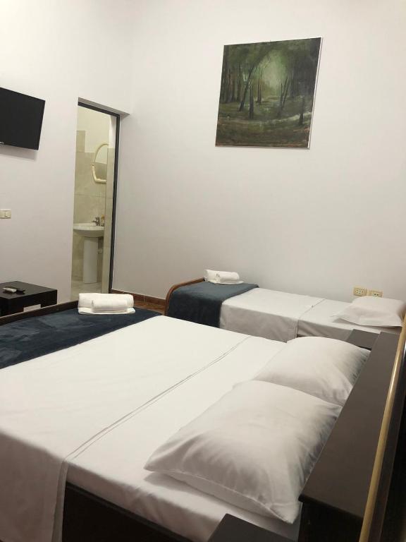 Postel nebo postele na pokoji v ubytování Hotel Xhej