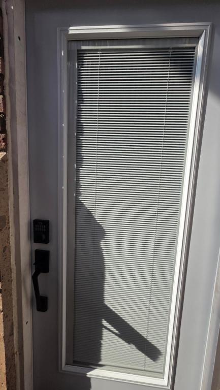 a shadow of a person looking out of a window at Serene Niagara Inn in Niagara Falls