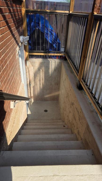 a stair case with stairs leading up to a building at Serene Niagara Inn in Niagara Falls