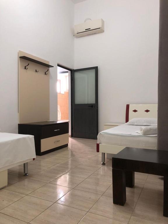 Postel nebo postele na pokoji v ubytování Hotel Xhej