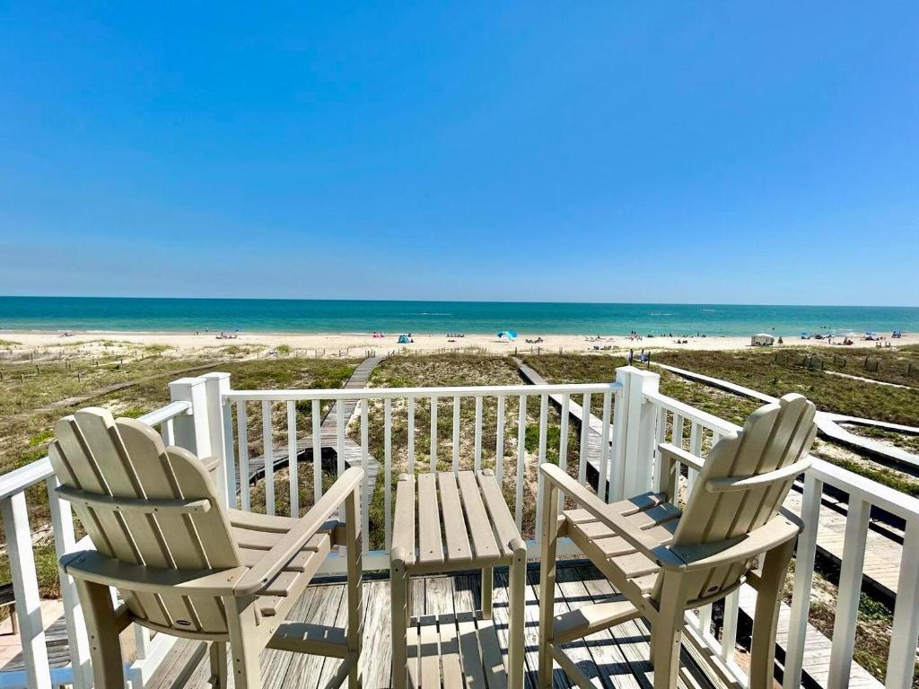 two chairs and a table on a deck overlooking the beach at Skinny Mini-Beachfront-3BR in St. George Island