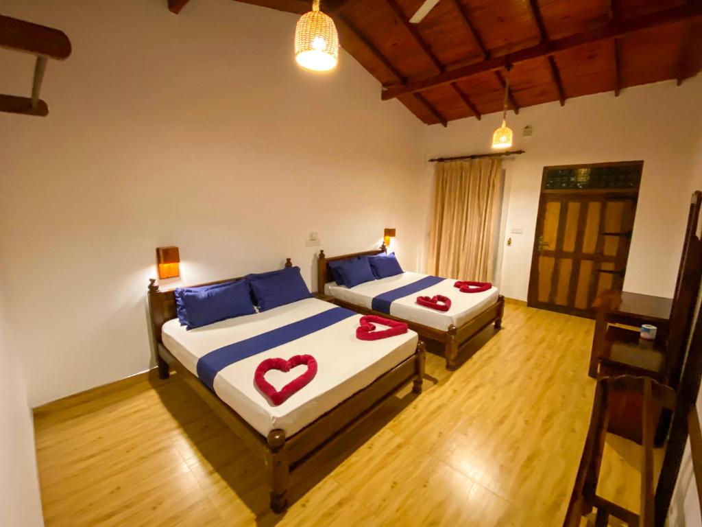 a bedroom with two beds with hearts on them at Oasis Bay - Arugam Bay in Arugam Bay
