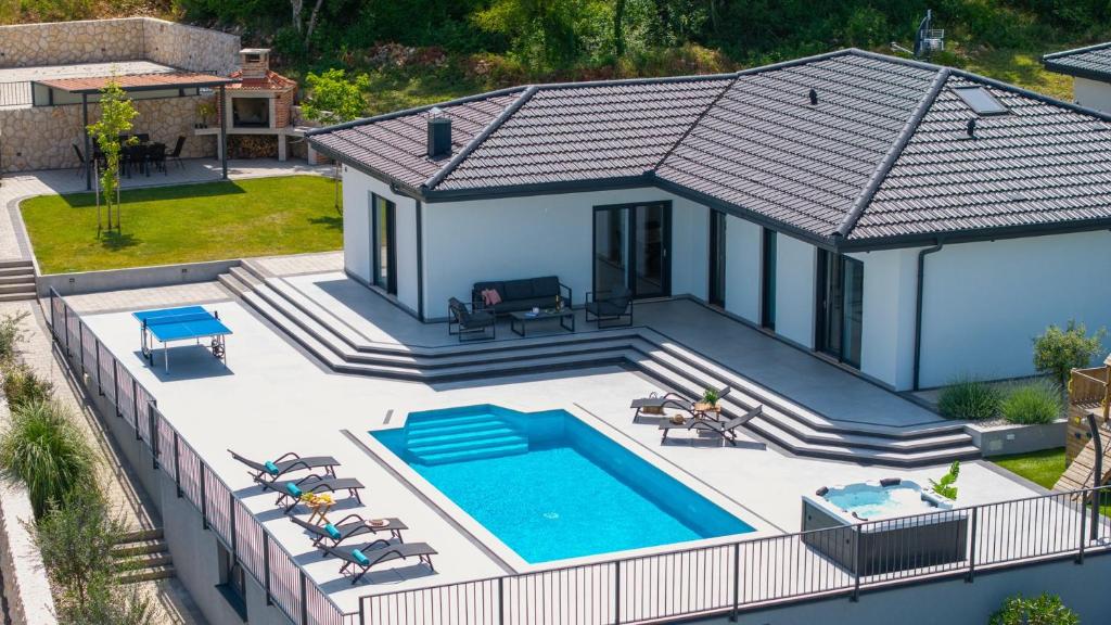 an aerial view of a house with a swimming pool at NEW! Villa Dalmatia with Sauna, Hot tub, Heated pool in Grubine