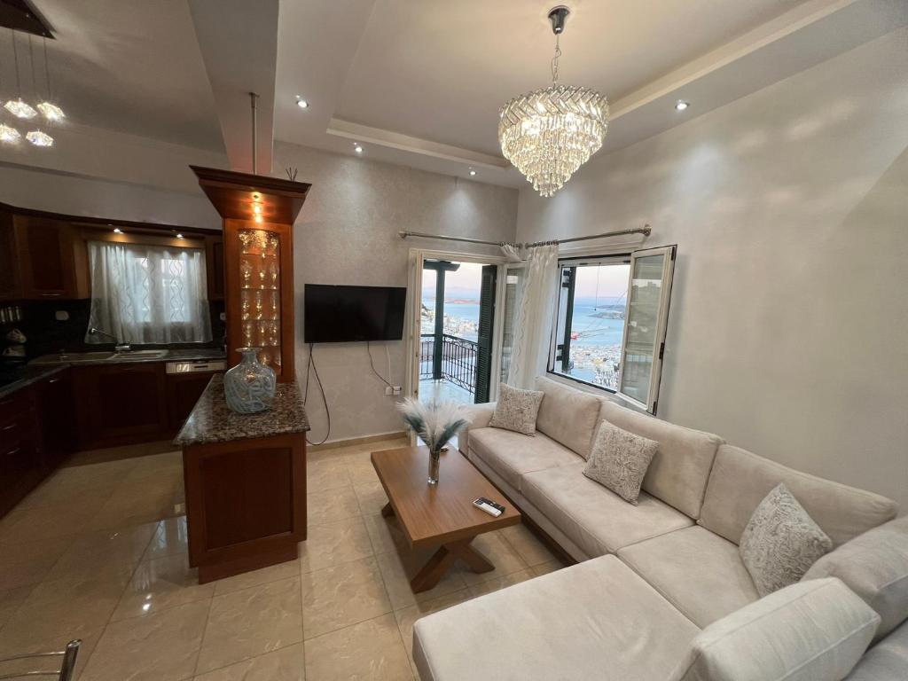 a living room with a couch and a table at Akadia Syros in Ermoupoli