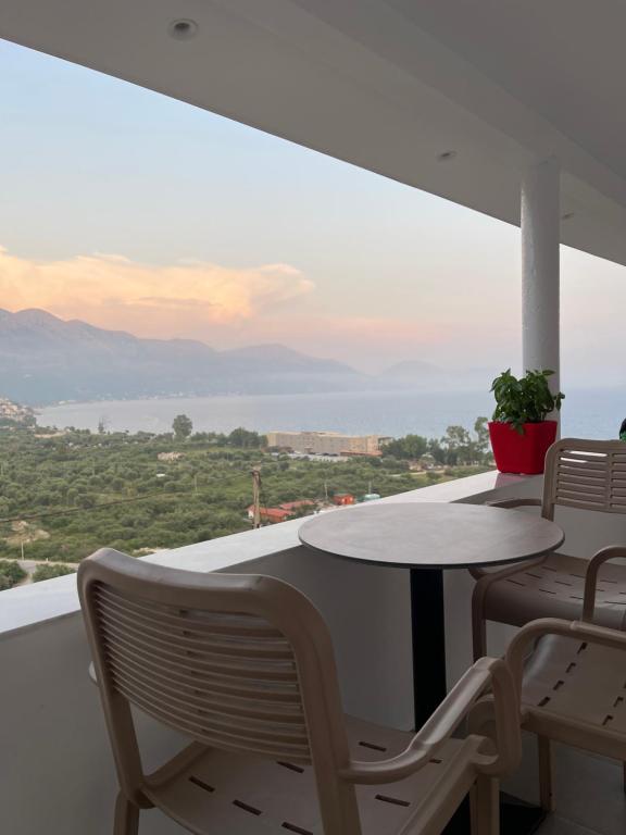 a table and chairs on a balcony with a view at Odore di Mare 2 in Qeparo