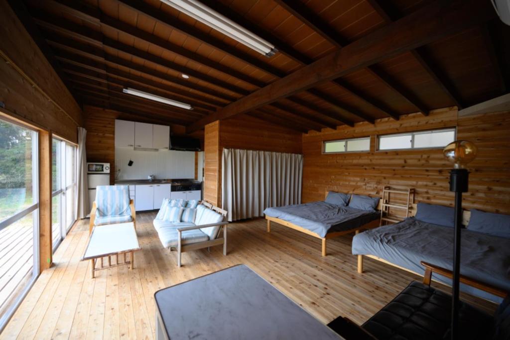 a living room with two beds and a kitchen at TOWA BEACH HOUSE IRITAHAMA - Vacation STAY 06102v in Shimoda