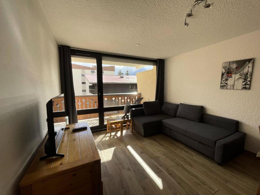 un salon avec un canapé et une grande fenêtre dans l'établissement Résidence Soldanelle - Agréable studio exposé sud au départ des pistes MAE-6601, à Vénosc
