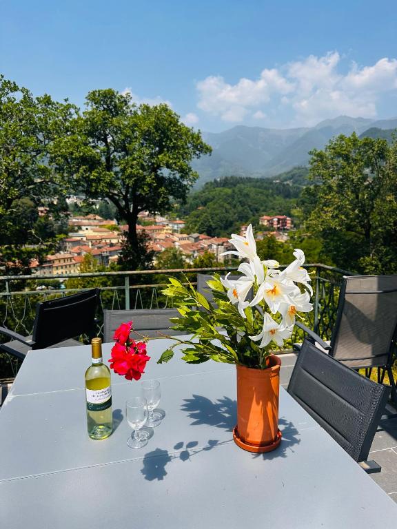 a table with a bottle of wine and flowers on it at Sole di Bagnone in Bagnone
