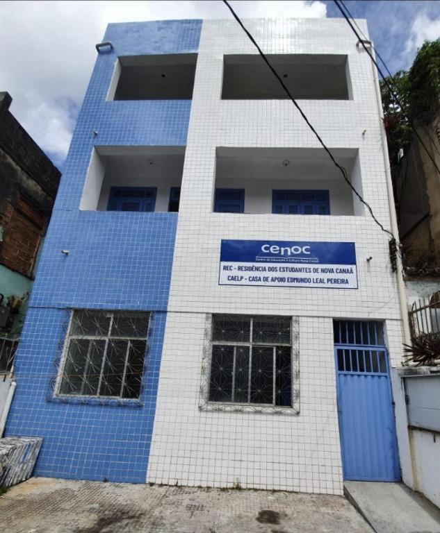 a blue and white building with a sign on it at C&R hostel residência in Salvador