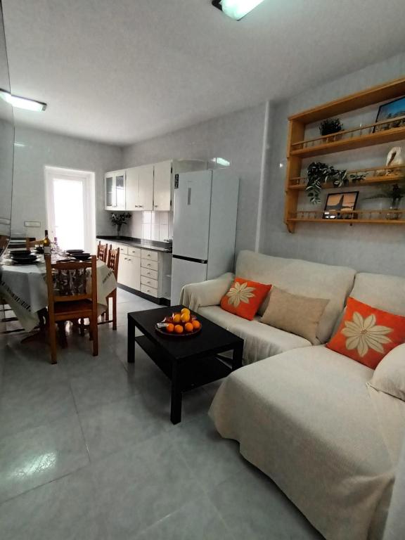 a living room with a couch and a table at Apartamento Brañas Home1 in Cambados
