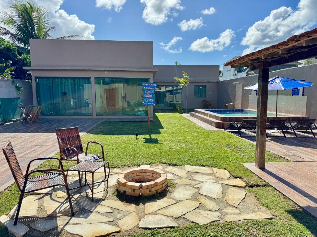 a patio with two chairs and a fire pit at BayShore Loft in Cabo Frio