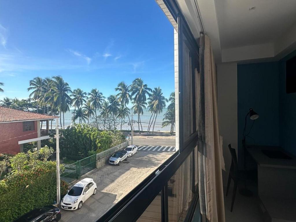 a balcony with two cars parked in a parking lot at Loft 306 Imperial Suites in João Pessoa