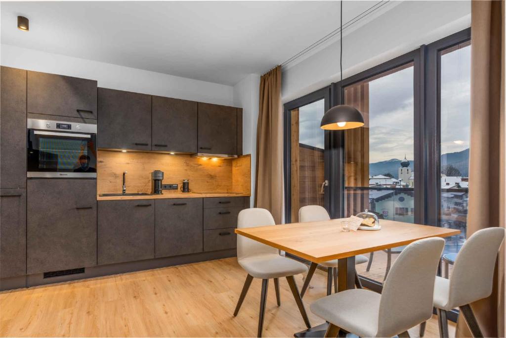a kitchen and dining room with a table and chairs at Apartment in Lam - Bayerischer Wald 50007 in Lam