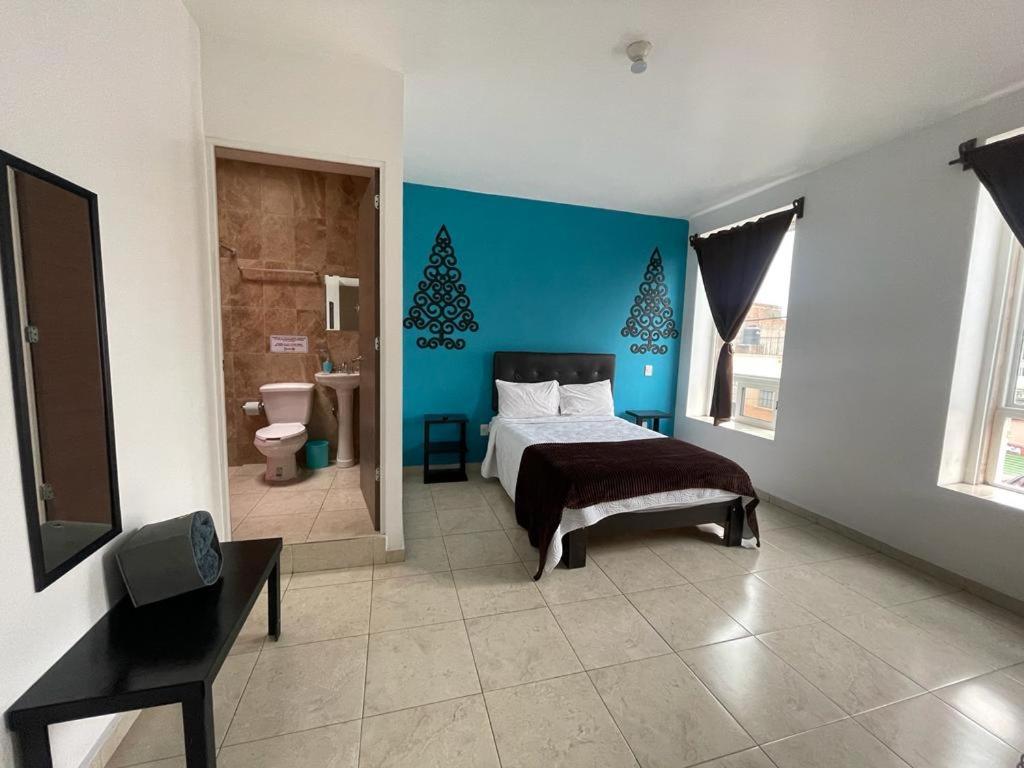 Una cama o camas en una habitación de Manuel Muñiz