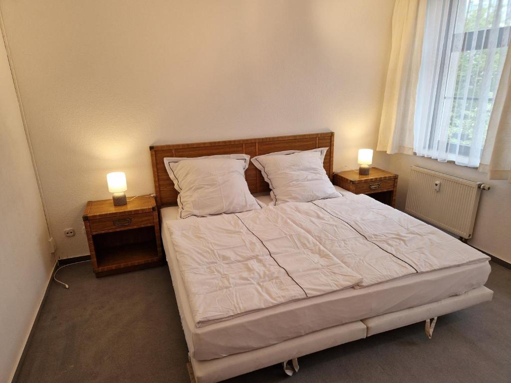 a bedroom with a large bed with two night stands at Gästezimmer North Carolina in Chemnitz in Chemnitz