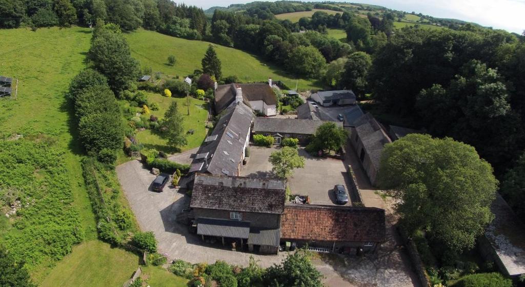 an aerial view of an old house in a field at Budleigh Farm Cottages in Moretonhampstead