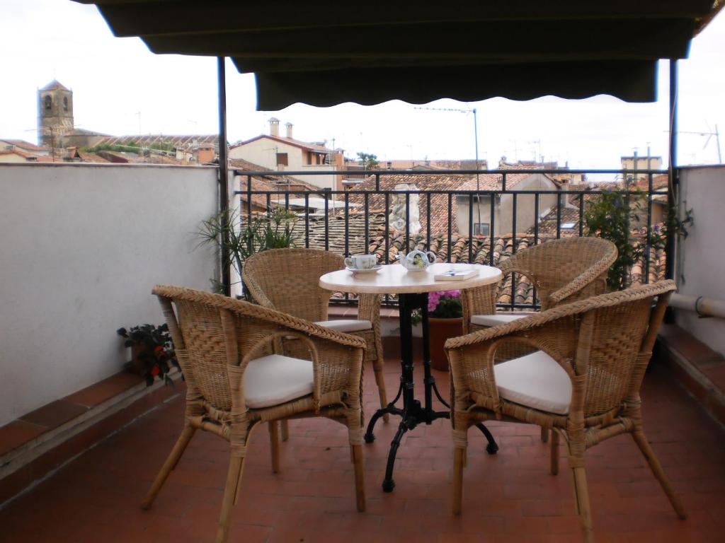 a table and chairs on top of a balcony at Casco Viejo Candeleda in Candeleda