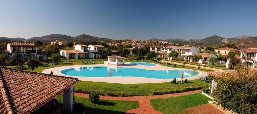 an overhead view of a large swimming pool in a residential neighborhood at Le Tre Querce in San Teodoro