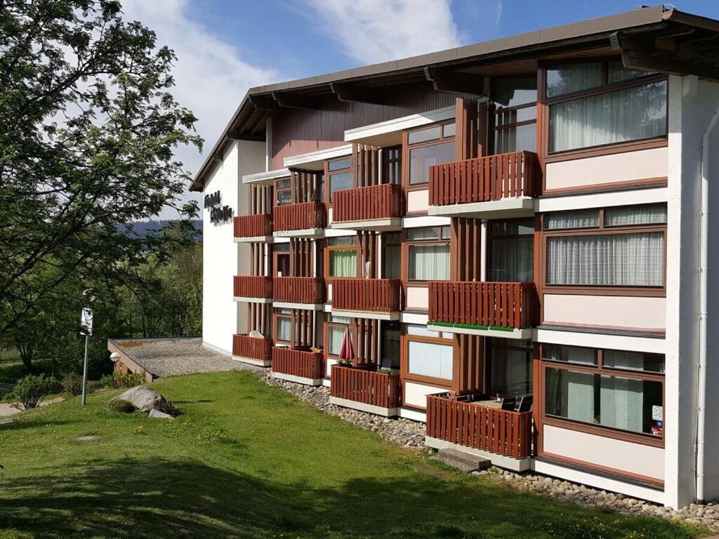 a building with red balconies on the side of it at Schluchseestube 3309 in Schluchsee