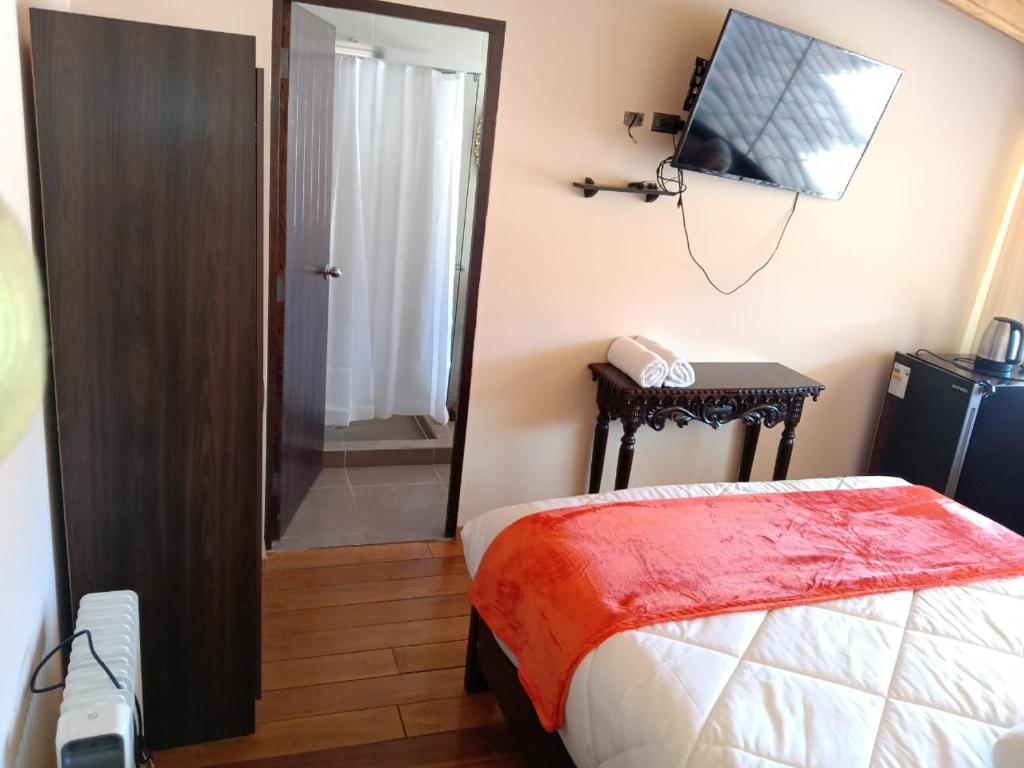 Ένα ή περισσότερα κρεβάτια σε δωμάτιο στο Casona Tupac Hotel Cusco