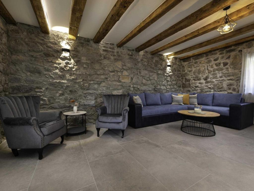 a living room with a blue couch and chairs at Luxury Krk Villa with Private Pool and Gardens - Three Bedroom Villa in Krk