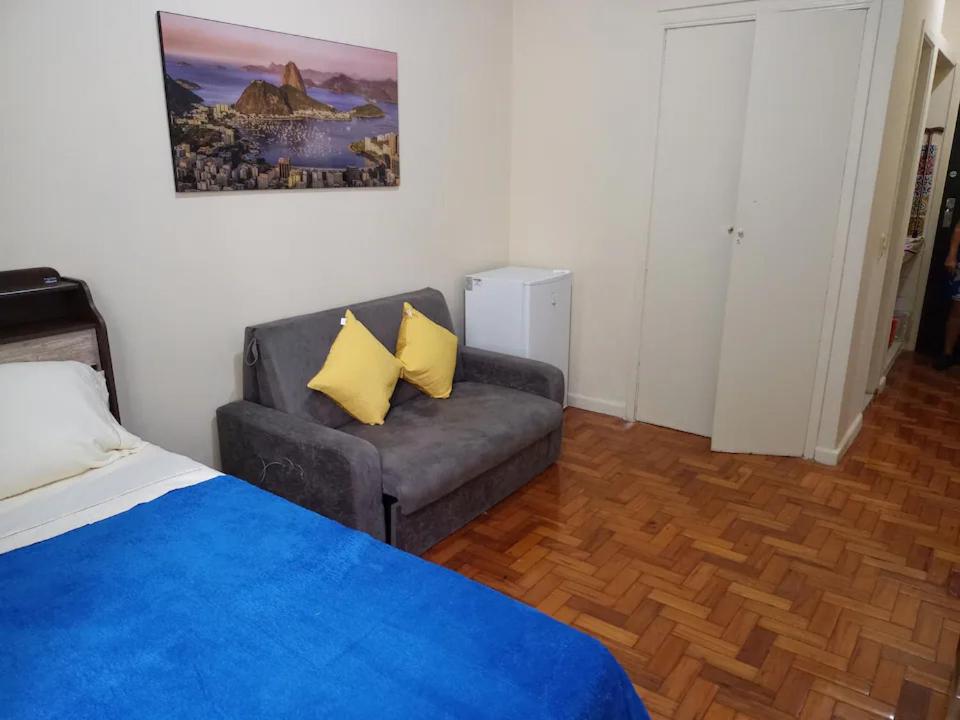 una sala de estar con un sofá y una silla en Kitnet na Princesa Isabel no 10 andar, en Río de Janeiro