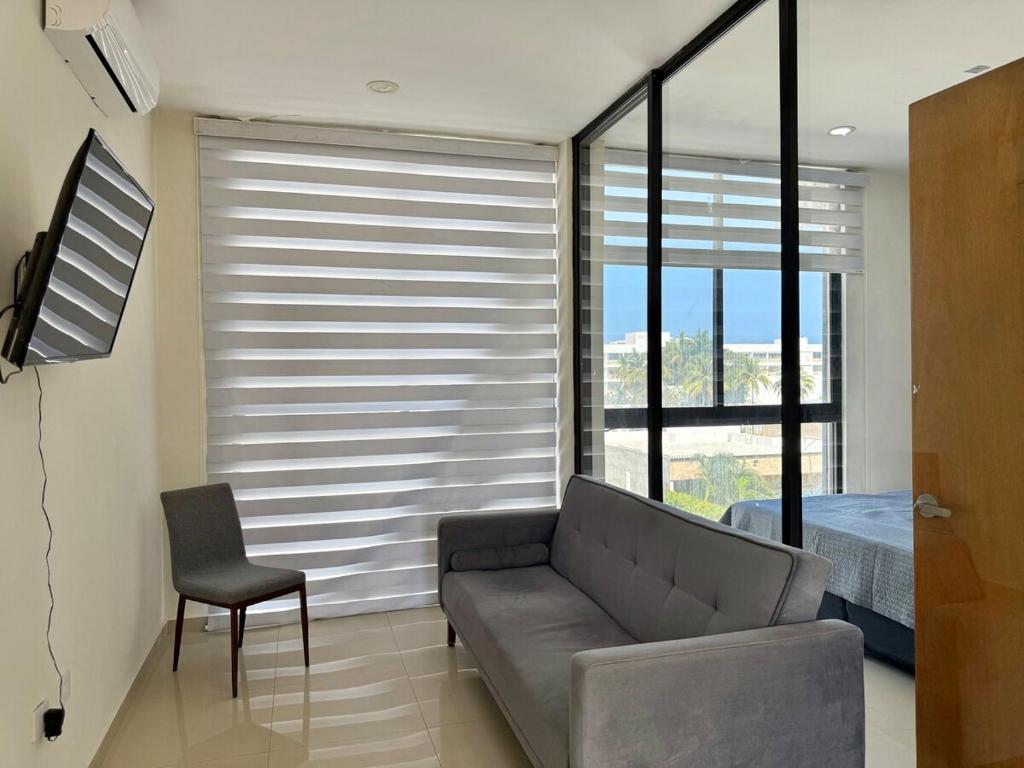 a living room with a couch and a window at Loft a few blocks from the beach in Mazatlán
